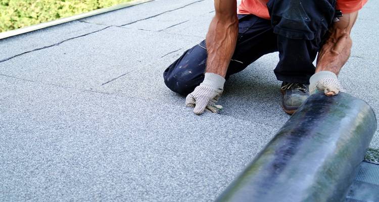 man laying felt roof