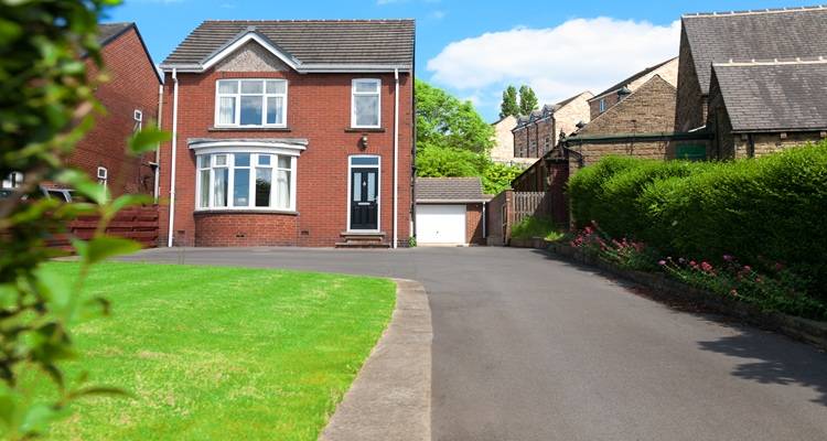 big driveway red brick house