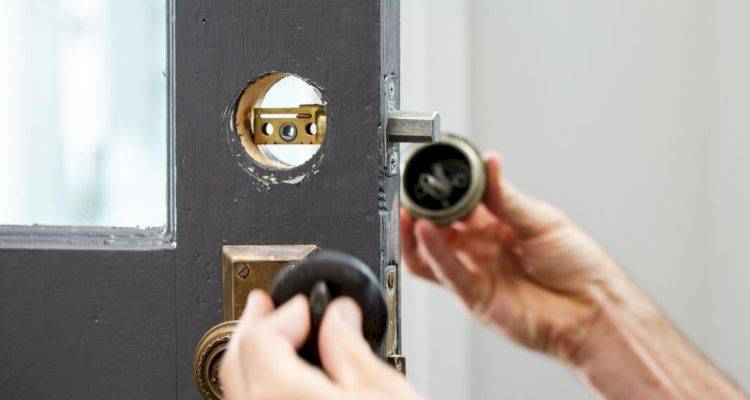 locksmith removing the lock on a door
