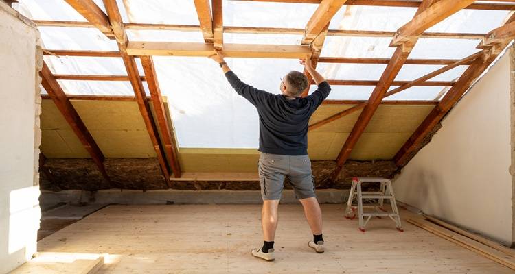 man fitting insulation dormer loft