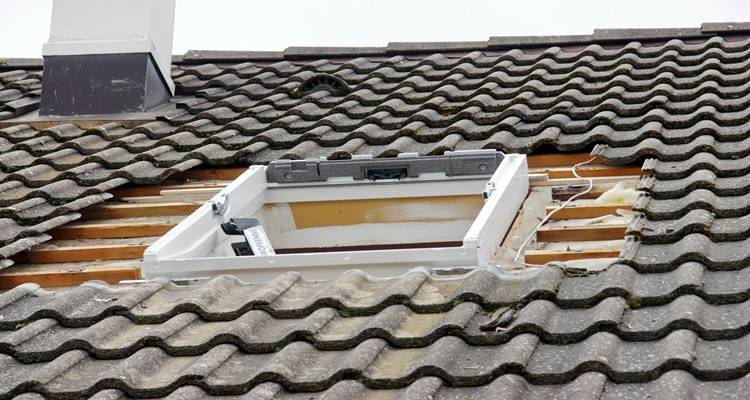 velux hole in roof tiles surrounding