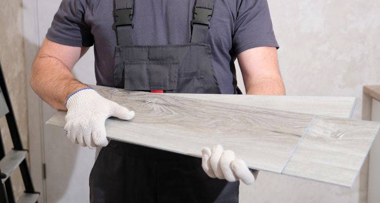 person holding vinyl flooring planks