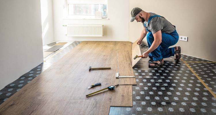 man fitting vinyl flooring planks